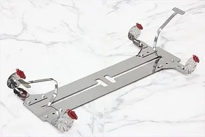 A set of four red RC brake calipers mounted on metal brackets and circular brake discs, displayed on a white marble surface.