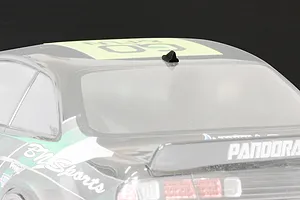 A small black shark fin style roof antenna mounted on the roof of a 1/10 scale RC car body shell.