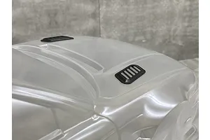Two black bonnet duct accessories installed on a clear, unpainted 1/10 scale RC car body shell.