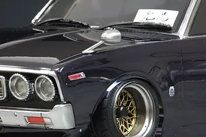 Close-up of a silver fender mirror mounted on the hood of a dark blue 1/10 scale RC car body shell.