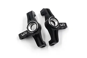 A pair of black anodized aluminium C-hub carriers for RC cars by Yeah Racing, featuring silver-edged bearing seats and the YR logo.