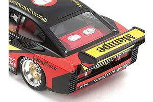Close-up rear view of a Tamiya 1/24 scale 1978 Ford Zakspeed Capri Turbo model car featuring Mampe livery, black and red paint, and Goodyear tire branding.