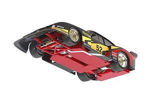 Low angle view of the underside of a Tamiya 1/24 scale 1978 Ford Zakspeed Capri Turbo model car, showing the red chassis, suspension, and racing livery.