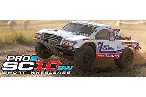 Team Associated Pro2 SC10sw RC short course truck driving on a dirt track with white body and racing decals.