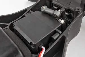 Close-up of a steering servo mounted in the chassis of a Team Associated RC short course truck.
