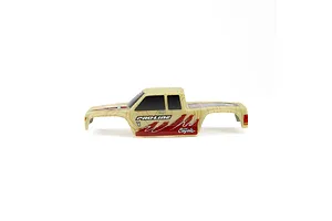 A side view of a pre-painted Pro-Line Coyote RC truck body shell featuring a tan topographical pattern with red and white graphic accents.
