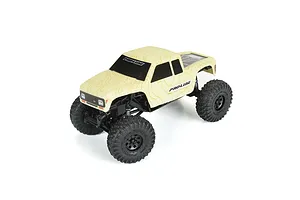 Pro-Line Coyote body shell in tan topographical pattern mounted on a small RC crawler chassis.