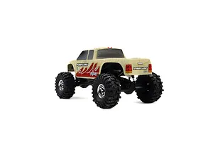 A Pro-Line Coyote RC crawler body shell in tan topographical print, mounted on a chassis with black off-road tires and chrome wheels.
