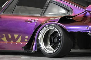 Close-up of a purple RWB RC car body showing the Idlers tyre decal applied to the sidewall of the rear tyre.