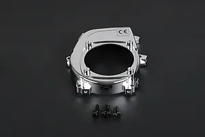 A chrome-finished Rovan RC engine cover with a central circular opening and five small black mounting screws placed below it on a dark background.