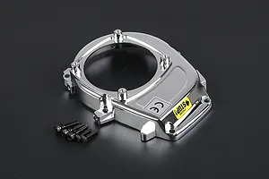 A chrome-plated Rovan RC engine cover with a yellow engine stop sticker and four included mounting screws on a dark background.