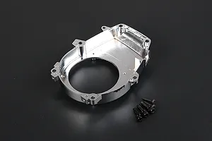 A chrome-finished RC engine cover with mounting holes and a set of four small black screws on a dark background.