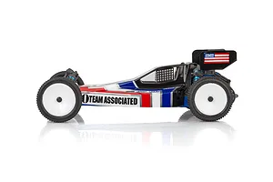 Side profile of a Team Associated RB10 1/10 scale RC buggy with a red, white, and blue retro livery on a white background.