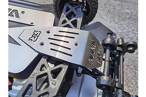A stainless steel chassis skid plate installed on an Arrma Senton RC vehicle, featuring a hollowed-out design with the Senton logo engraved.