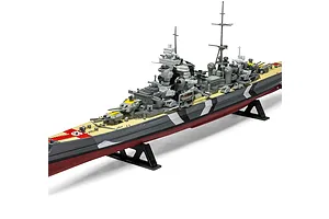A completed 1/600 scale plastic model of the German heavy cruiser Prinz Eugen, featuring a distinctive camouflage pattern and mounted on a black display stand.