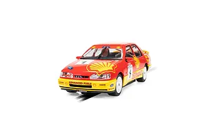 A 1/32 scale Scalextric Ford Sapphire RS500 slot car in red and yellow Shell racing livery, featuring number 1 and Rod Gravett branding.