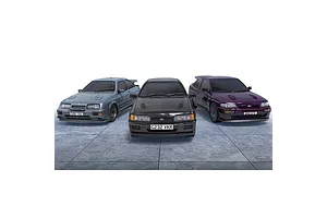 Three Scalextric 1/32 scale Ford RS slot cars in grey, black, and purple parked on a tiled surface.