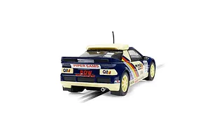 Rear three-quarter view of a Scalextric 1/32 scale Ford RS200 slot car in blue and cream livery with Q8 Oils branding on a track.