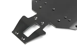 A close-up view of a black anodized aluminium RC car main chassis plate with various mounting holes and a central cutout.