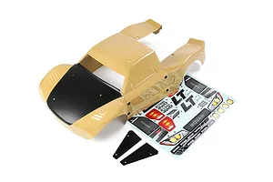 A tan and black Rovan 1/5 scale short course RC truck body shell with a decal sheet and two small black plastic trim pieces on a white background.