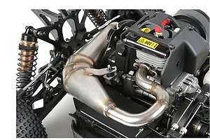 Close-up of a stainless steel tuned exhaust pipe installed on a large-scale RC buggy engine.