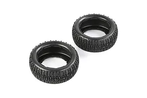 Two black rubber RC short course truck tyres with a blocky tread pattern, viewed from an angle against a white background.