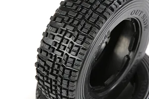 Close-up of Rovan 1/5 scale RC short course truck front tyres with a blocky tread pattern, showing the sidewall markings.