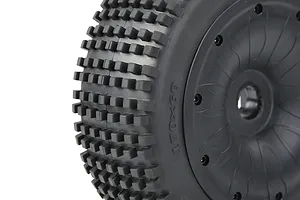 Close-up of a black RC buggy wheel with a knobby Dirt Buster tread pattern and a closed black rim.