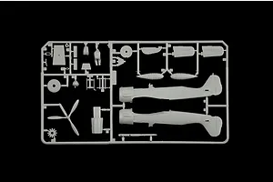 A grey plastic sprue from an Italeri 1/72 scale model aircraft kit, featuring fuselage halves, a propeller, and various small cockpit and engine parts.