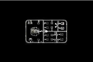 A clear plastic sprue containing transparent model helicopter parts, including a cockpit canopy and various windows, set against a black background.