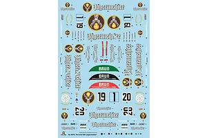 A decal sheet for the Italeri 1/24 Porsche 956 Jägermeister model kit, featuring various logos, racing numbers, and sponsor decals on a light blue backing.