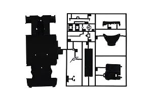 A black plastic model kit sprue containing various car parts including a chassis plate, steering wheel, and seat, isolated on a white background.