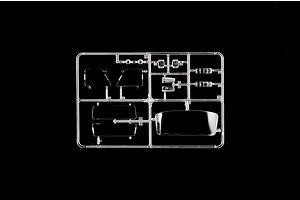 A clear plastic sprue containing various transparent model car parts, including windows and light lenses, set against a solid black background.