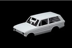 Unpainted white plastic model car body shell of a Range Rover on a black background.