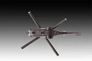 A top-down view of a 1/144 scale Westland Puma HC.1 helicopter model kit, showing the underside of the fuselage, landing gear, and rotor blades.
