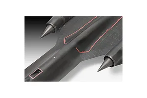 A close-up top-down view of a black SR-71 Blackbird plastic model aircraft showing engine nacelles and red warning markings on the fuselage.