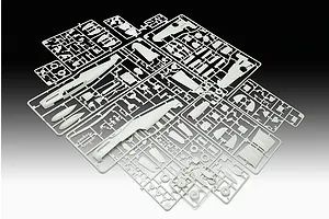 Several light grey plastic model kit sprues containing various aircraft parts for a Messerschmitt Bf109G-10 model, laid out on a gradient background.