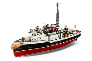 A fully assembled and painted 1/87 scale plastic model of the Fire Fighter fireboat, featuring a red hull, white superstructure, and detailed deck equipment.