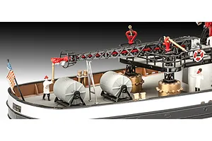 Close-up of the deck of a Revell 1/87 scale Firefighter boat model kit showing a crane, water cannons, and miniature figures.
