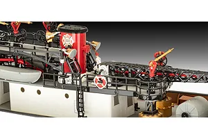 Close-up of the deck of a Revell 1/87 scale fireboat model kit showing a red funnel, railings, ladders, and miniature firefighter figures.