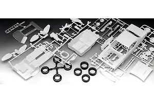 Unassembled plastic model car kit parts for a 1971 Plymouth GTX, including white body panels, interior, and black rubber tires on a black background.
