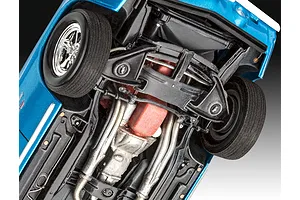 Underside view of a 1/24 scale Revell 1969 Chevy Camaro Yenko model car showing the chassis, engine block, exhaust, and front suspension.
