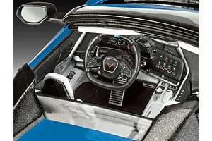 Close-up view of the detailed interior of a 1/25 scale Revell Corvette C8 Cabriolet model car, showing the dashboard, steering wheel, and center console.