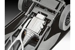 Close-up view of the underside of a 1/32 scale Jaguar SS 100 model car, showing the engine, transmission, and chassis details.