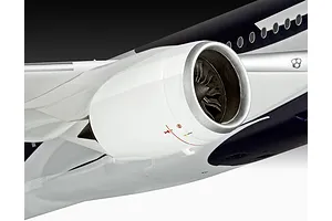 Close-up of a plastic model aircraft engine mounted on a wing, featuring white casing and dark fan blades.