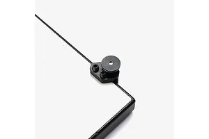 Close-up of a black aluminium corner bracket with adjustment screws attached to a white surface.