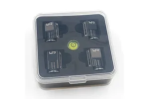 A set of four black Yeah Racing aluminium level blocks and a circular spirit level in a clear plastic storage case with black foam insert.