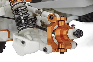 Close-up of the front suspension and steering knuckle assembly on a Team Associated RC monster truck.