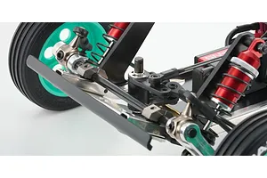 Close-up of the front suspension and steering assembly of a Kyosho Tomahawk RC buggy, featuring red shocks and teal wheels.