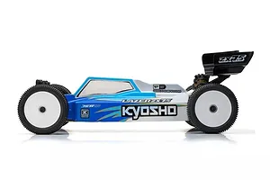 Side profile of a Kyosho Lazer ZX7.5 1/10 scale electric RC buggy with a blue and white painted body shell and white wheels.
